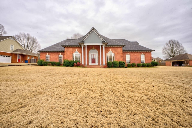 6384 Acree Woods Dr, Olive Branch, MS 38654 - neoclassical / greek revival house featuring brick siding, a front yard, and roof with shingles