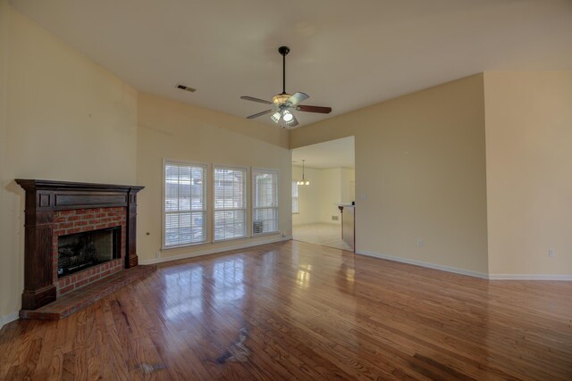 6384 Acree Woods Dr, Olive Branch, MS 38654 - unfurnished living room featuring a fireplace, a ceiling fan, wood finished floors, and a chandelier