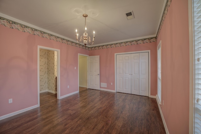 6384 Acree Woods Dr, Olive Branch, MS 38654 - unfurnished bedroom featuring a chandelier, dark wood-style floors, a closet, and ornamental molding