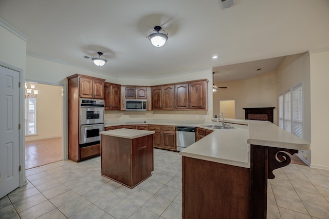 6384 Acree Woods Dr, Olive Branch, MS 38654 - kitchen with stainless steel appliances, a peninsula, light countertops, a center island, and light tile patterned floors