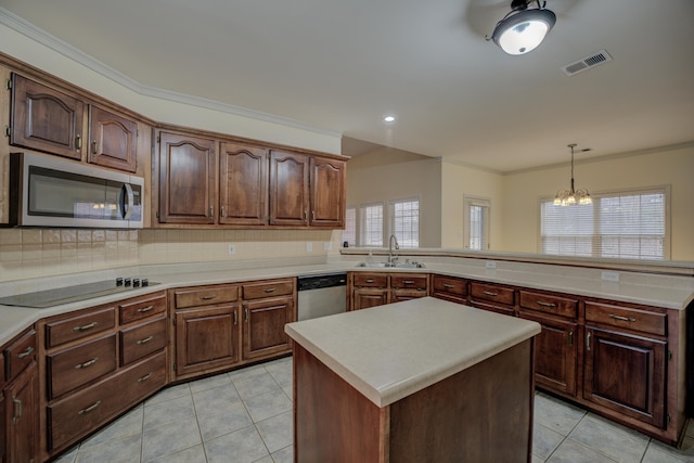 6384 Acree Woods Dr, Olive Branch, MS 38654 - kitchen with appliances with stainless steel finishes, a chandelier, light countertops, tasteful backsplash, and crown molding
