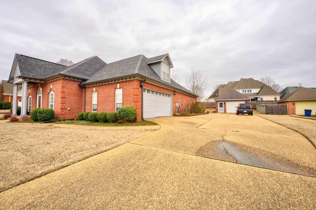 6384 Acree Woods Dr, Olive Branch, MS 38654 - view of home's exterior featuring brick siding, concrete driveway, roof with shingles, and an attached garage