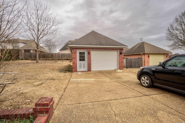 6384 Acree Woods Dr, Olive Branch, MS 38654 - view of property exterior featuring brick siding, driveway, an outbuilding, and roof with shingles