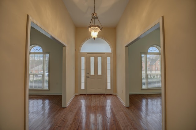 6384 Acree Woods Dr, Olive Branch, MS 38654 - entrance foyer with healthy amount of natural light, wood finished floors, a chandelier, and a towering ceiling