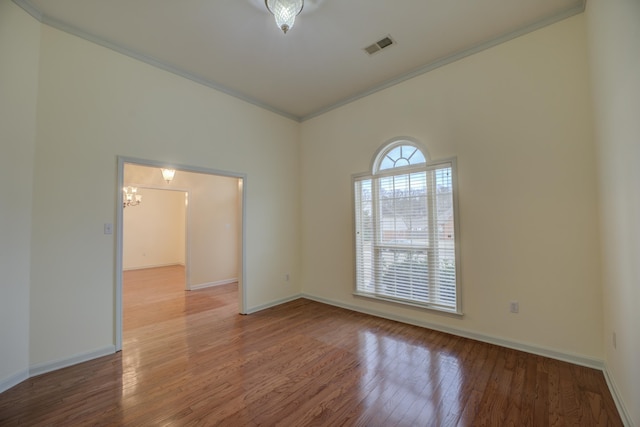 6384 Acree Woods Dr, Olive Branch, MS 38654 - spare room with crown molding, wood finished floors, and a chandelier