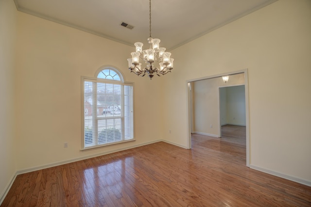 6384 Acree Woods Dr, Olive Branch, MS 38654 - spare room featuring wood finished floors and a chandelier