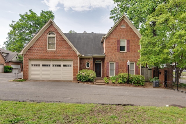 1501 Granville Ln, Memphis, TN 38104 - traditional-style house featuring brick siding, driveway, and a shingled roof