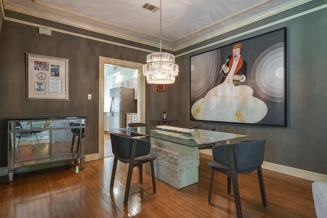 1501 Granville Ln, Memphis, TN 38104 - dining area featuring a chandelier, hardwood / wood-style floors, and crown molding