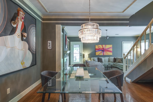 1501 Granville Ln, Memphis, TN 38104 - dining room featuring crown molding, wood finished floors, a chandelier, and stairs