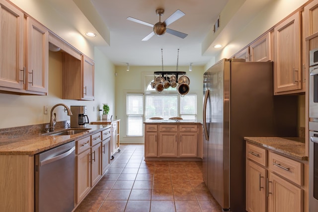 1501 Granville Ln, Memphis, TN 38104 - kitchen with appliances with stainless steel finishes, ceiling fan, light stone counters, tile patterned floors, and light brown cabinetry