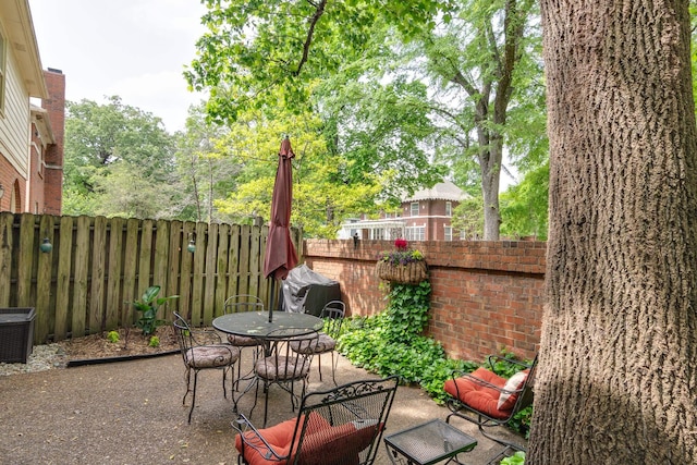 1501 Granville Ln, Memphis, TN 38104 - fenced backyard featuring a patio and outdoor dining area
