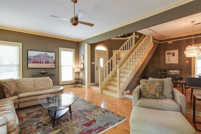 1501 Granville Ln, Memphis, TN 38104 - living area with stairway, a ceiling fan, a chandelier, ornamental molding, and wood finished floors