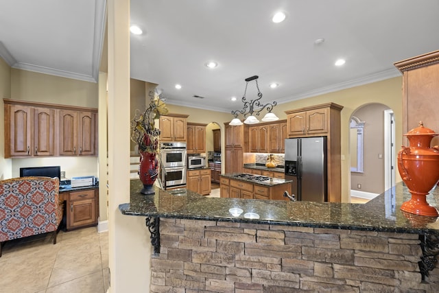 11095 Latting Rd, Eads, TN 38028 - kitchen featuring stainless steel appliances, arched walkways, dark stone counters, ornamental molding, and recessed lighting
