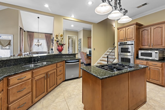 11095 Latting Rd, Eads, TN 38028 - kitchen with appliances with stainless steel finishes, dark stone countertops, ornamental molding, a chandelier, and hanging light fixtures