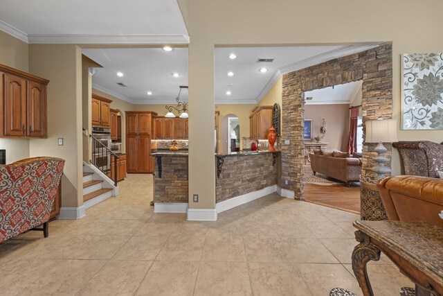 11095 Latting Rd, Eads, TN 38028 - kitchen featuring open floor plan, crown molding, arched walkways, brown cabinets, and light tile patterned floors