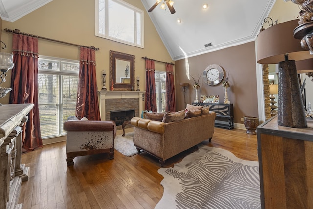 11095 Latting Rd, Eads, TN 38028 - living room featuring a stone fireplace, high vaulted ceiling, crown molding, a ceiling fan, and wood-type flooring