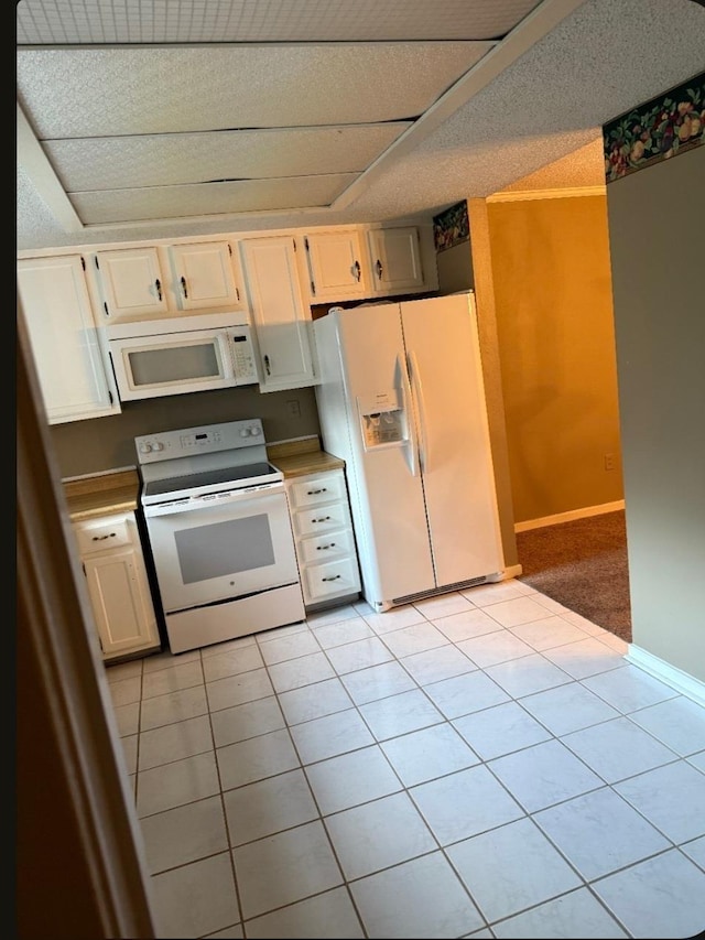 4779 Towering Oaks Dr Unit 704, Memphis, TN 38117 - kitchen featuring white appliances, light tile patterned floors, and white cabinetry