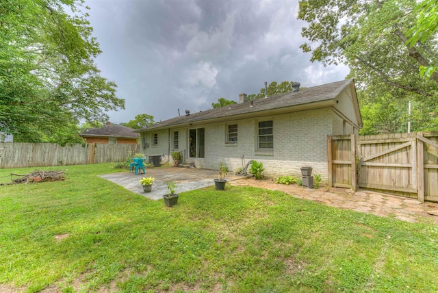 4427 Quince Rd, Memphis, TN 38117 - back of house featuring brick siding, a patio, a fenced backyard, a gate, and a chimney