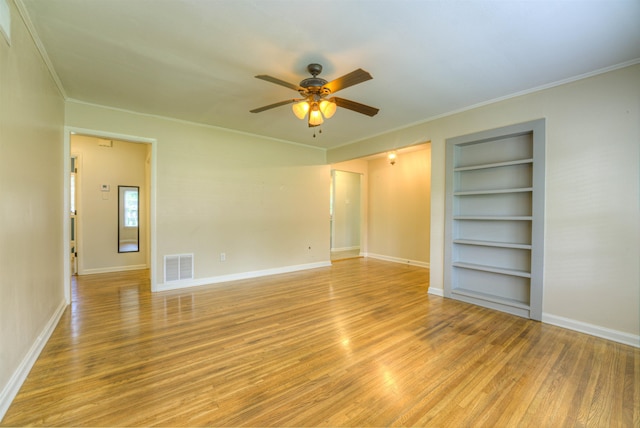 4427 Quince Rd, Memphis, TN 38117 - spare room with built in features, light wood-type flooring, a ceiling fan, and crown molding