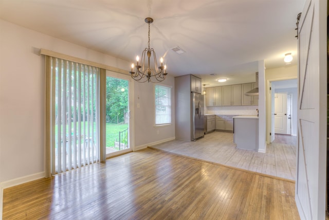 4427 Quince Rd, Memphis, TN 38117 - kitchen featuring gray cabinetry, a chandelier, stainless steel fridge, light countertops, and light wood-style flooring