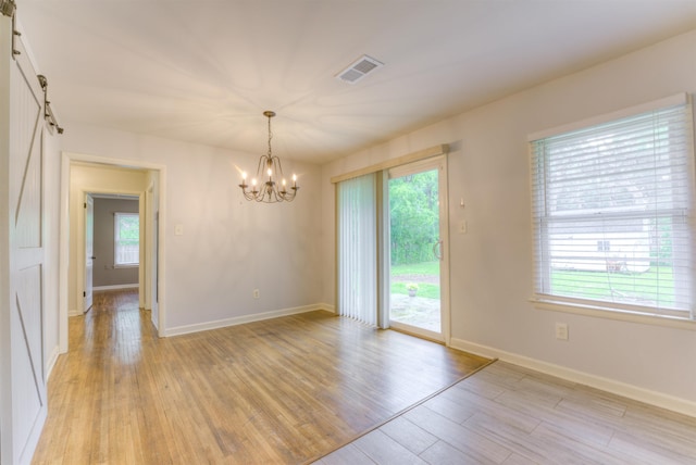 4427 Quince Rd, Memphis, TN 38117 - unfurnished room featuring a chandelier and light wood finished floors