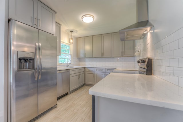 4427 Quince Rd, Memphis, TN 38117 - kitchen featuring stainless steel appliances, wall chimney exhaust hood, gray cabinets, backsplash, and light stone countertops