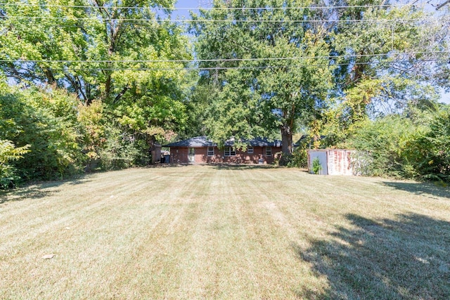 1539 Eason Ave, Memphis, TN 38116 - view of green lawn with a storage unit