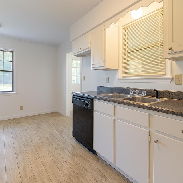 1539 Eason Ave, Memphis, TN 38116 - kitchen with dishwasher, dark countertops, plenty of natural light, and white cabinetry