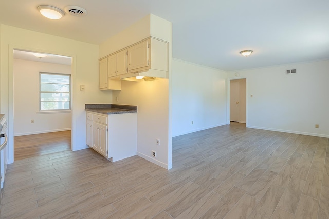 1539 Eason Ave, Memphis, TN 38116 - kitchen with light wood-type flooring, dark countertops, ornamental molding, and open floor plan