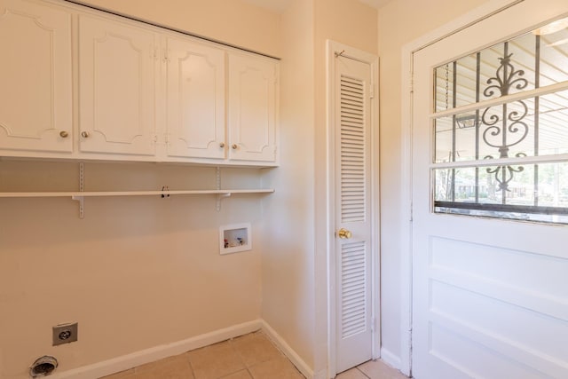 1539 Eason Ave, Memphis, TN 38116 - laundry room featuring hookup for an electric dryer, washer hookup, cabinet space, and light tile patterned floors