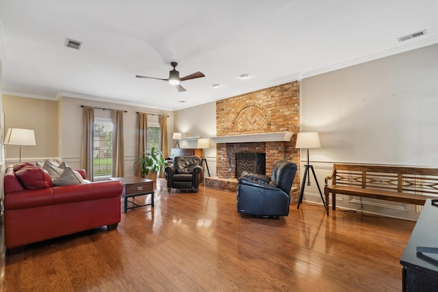 1231 Pinnacle Point Dr, Collierville, TN 38017 - living room with ornamental molding, wood finished floors, ceiling fan, and a brick fireplace