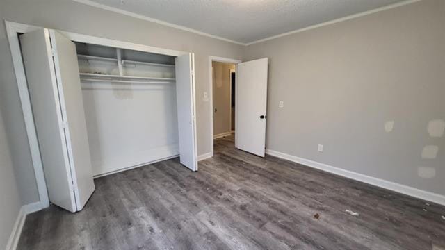 3499 Rockwood Ave, Memphis, TN 38122 - unfurnished bedroom featuring dark wood-type flooring, a closet, and ornamental molding