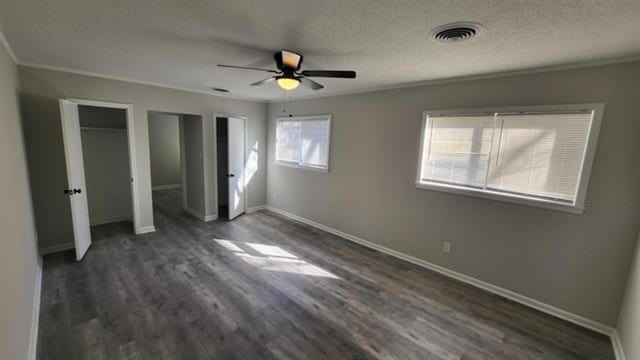 3499 Rockwood Ave, Memphis, TN 38122 - unfurnished bedroom with multiple closets, dark wood-style flooring, crown molding, a textured ceiling, and ceiling fan