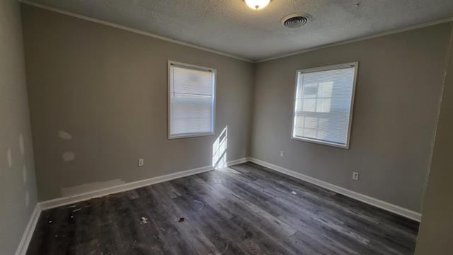 3499 Rockwood Ave, Memphis, TN 38122 - empty room with ornamental molding, dark wood-style floors, healthy amount of natural light, and a textured ceiling