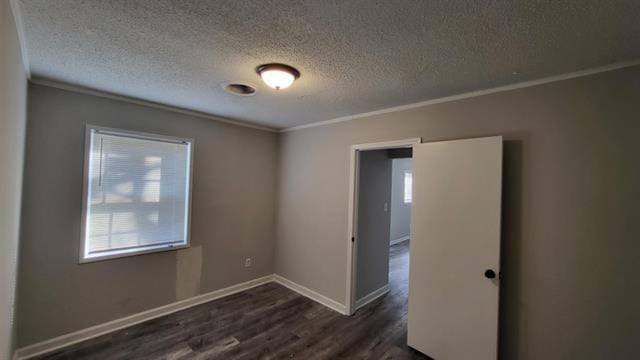 3499 Rockwood Ave, Memphis, TN 38122 - empty room with ornamental molding, dark wood-style flooring, and a textured ceiling