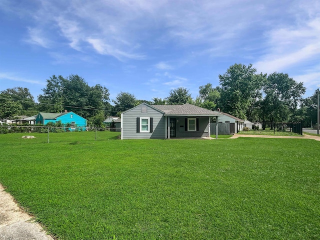 1644 N Graham St, Memphis, TN 38108 - view of yard featuring driveway, a carport, and view of wooded area