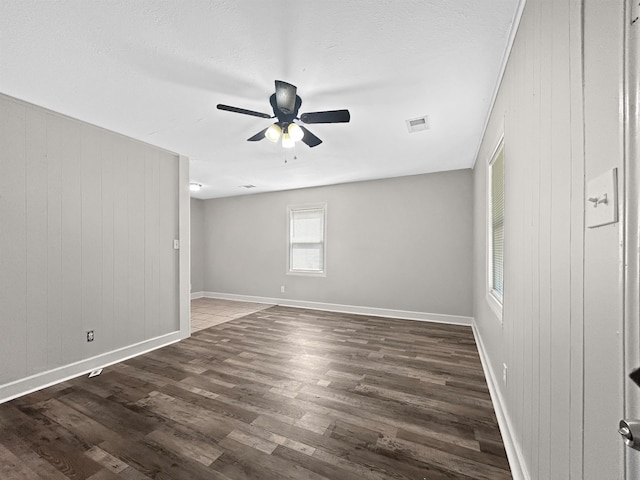 1644 N Graham St, Memphis, TN 38108 - empty room with a ceiling fan, wood finished floors, and wooden walls