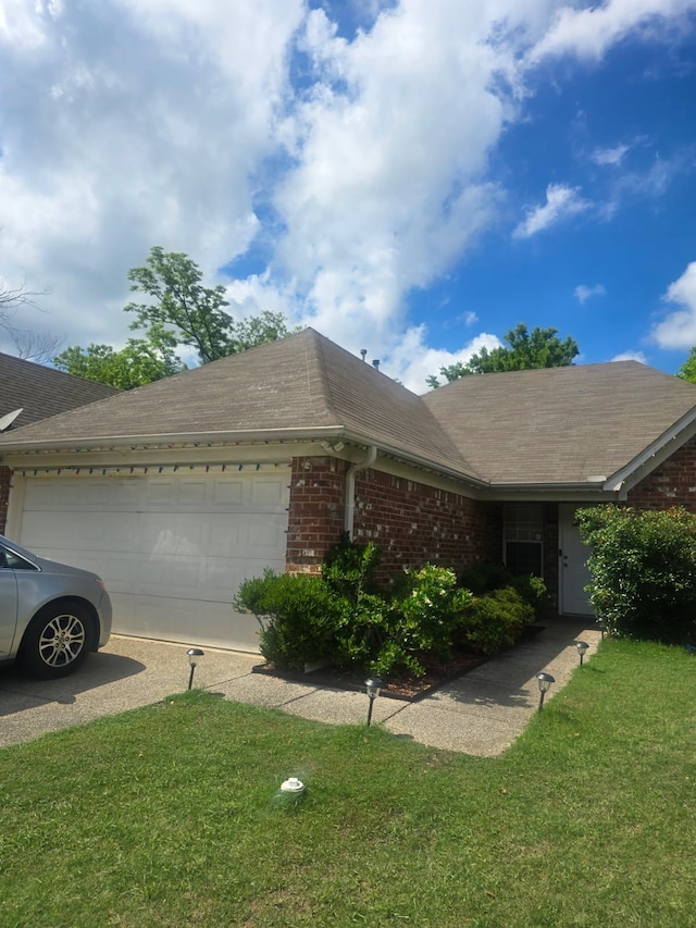 4568 Perkins Grove Cv, Memphis, TN 38122 - view of front of property featuring brick siding, a garage, a front lawn, and a shingled roof