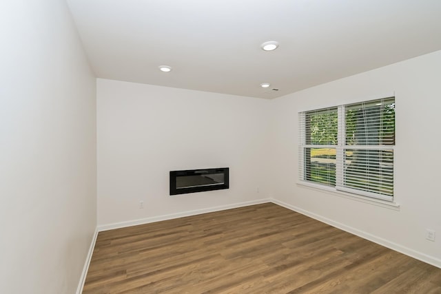 4130 Cottonwood Rd, Memphis, TN 38118 - unfurnished living room featuring wood finished floors, recessed lighting, and a glass covered fireplace