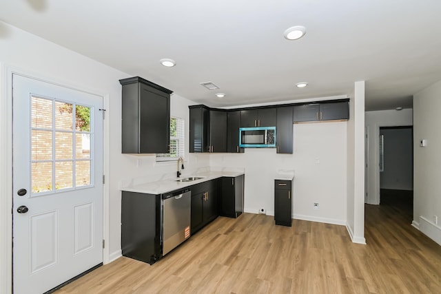 4130 Cottonwood Rd, Memphis, TN 38118 - kitchen with stainless steel appliances, light wood-type flooring, dark cabinetry, and recessed lighting