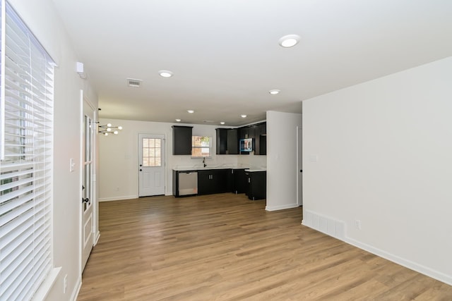 4130 Cottonwood Rd, Memphis, TN 38118 - unfurnished living room with light wood-style floors, recessed lighting, and a chandelier