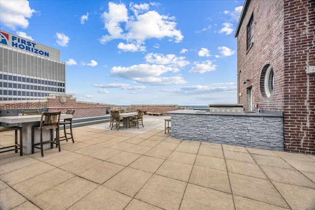 127 Madison Ave Unit 602, Memphis, TN 38103 - view of patio with outdoor dining space and an outdoor kitchen