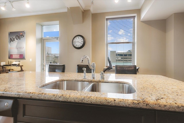 127 Madison Ave Unit 602, Memphis, TN 38103 - kitchen featuring light stone counters, plenty of natural light, and ornamental molding
