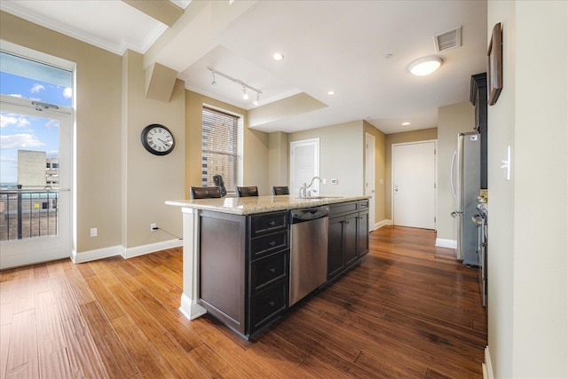 127 Madison Ave Unit 602, Memphis, TN 38103 - kitchen with stainless steel appliances, an island with sink, dark wood-type flooring, crown molding, and light stone countertops