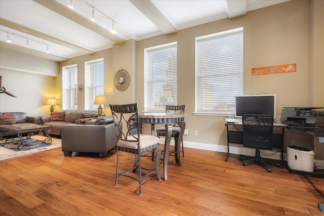 127 Madison Ave Unit 602, Memphis, TN 38103 - living room featuring rail lighting, hardwood / wood-style flooring, beamed ceiling, and healthy amount of natural light