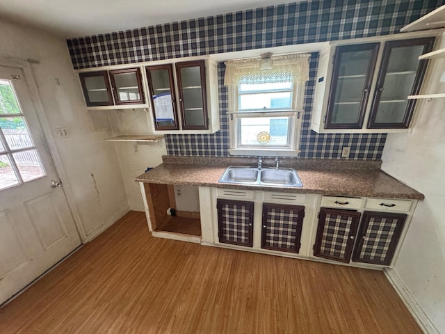 1445 Depass St, Memphis, TN 38122 - kitchen featuring wood finished floors, plenty of natural light, glass insert cabinets, and tasteful backsplash
