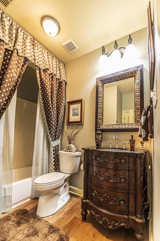 190 Links View Dr, Oakland, TN 38060 - bathroom featuring wood finished floors, vanity, and shower / bathtub combination with curtain