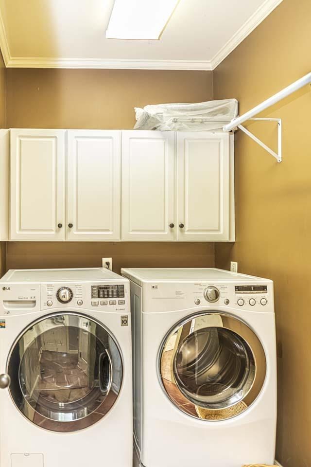 190 Links View Dr, Oakland, TN 38060 - laundry room featuring cabinet space, washing machine and dryer, and crown molding