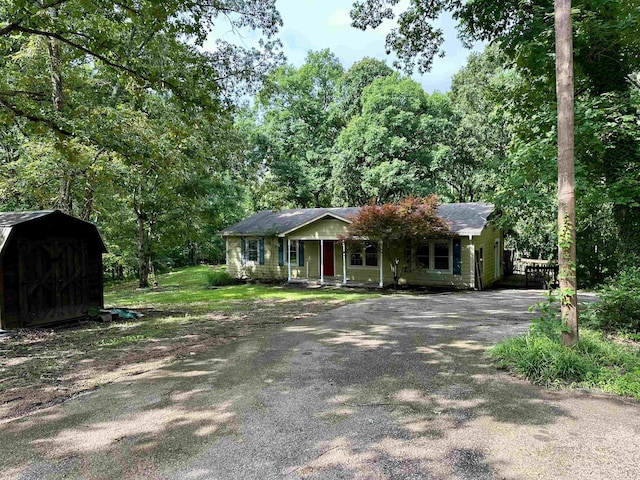 1790 Country Club Rd, Somerville, TN 38068 - view of front of house with a storage shed, covered porch, and asphalt driveway