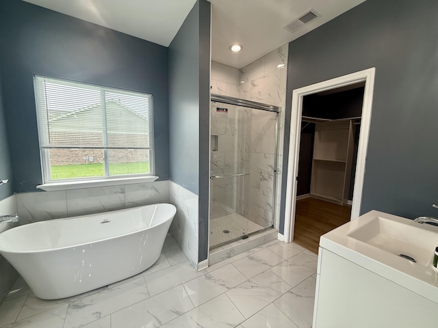 32 Foxchase Dr, Mason, TN 38049 - full bathroom featuring marble finish floors, a freestanding bath, a marble finish shower, a spacious closet, and vanity